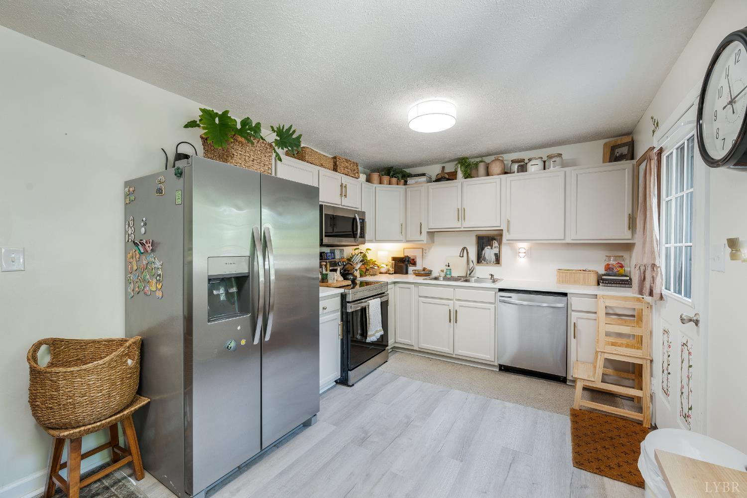 778 Doss Road Concord, VA 24538 - Photo 7 of 42 a kitchen with granite countertop a refrigerator and wooden floor