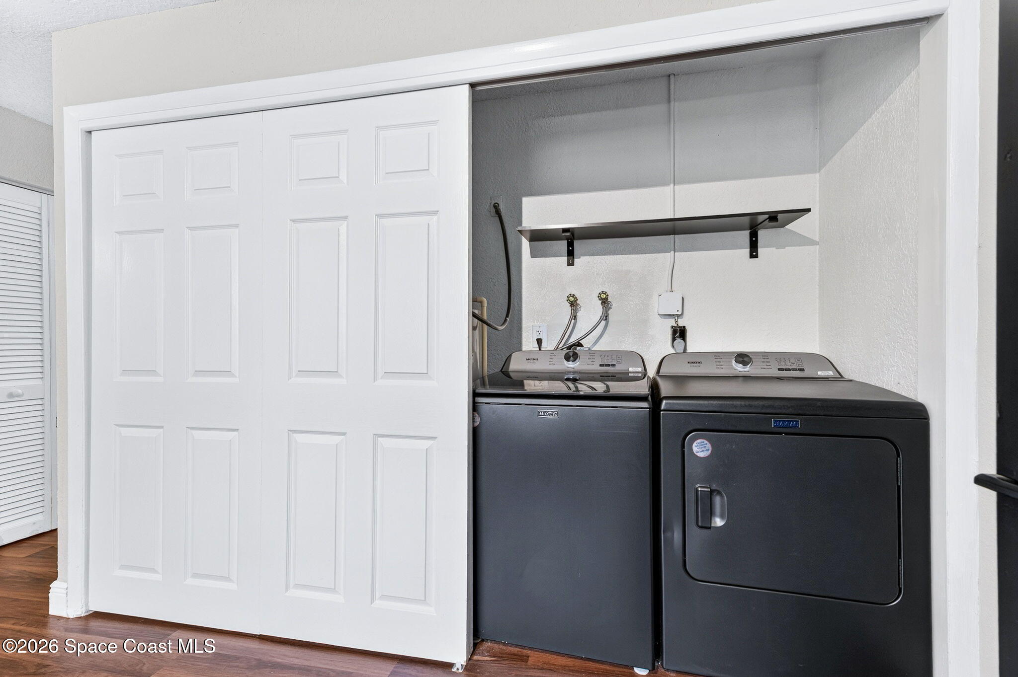 996 Botany Lane Rockledge, FL 32955 - Photo 28 of 35 a kitchen with a refrigerator and cabinets