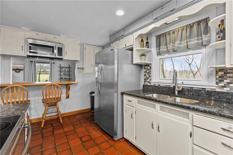 100 Daugherty Road Grove City, PA 16127 - Photo 6 of 48 a kitchen with stainless steel appliances granite countertop a refrigerator a stove and a sink with cabinets