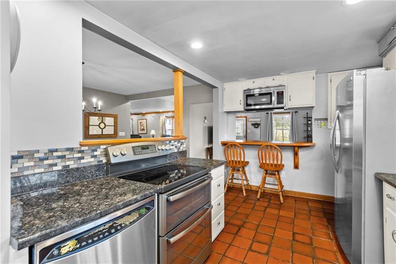100 Daugherty Road Grove City, PA 16127 - Photo 8 of 48 a kitchen with stainless steel appliances granite countertop a stove a sink and a refrigerator