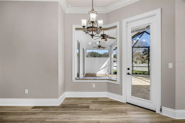 a view of a room with wooden floor
