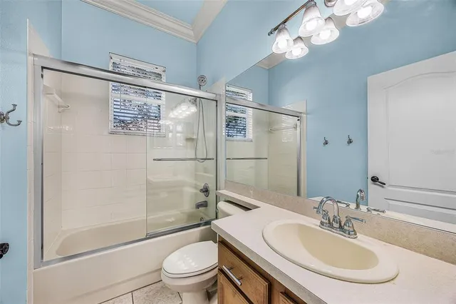 a bathroom with a granite countertop sink mirror vanity and toilet