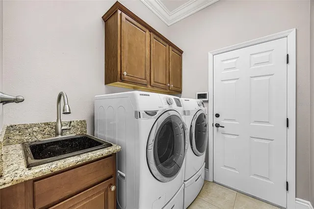 a view of a lake with table and chairs under an umbrella