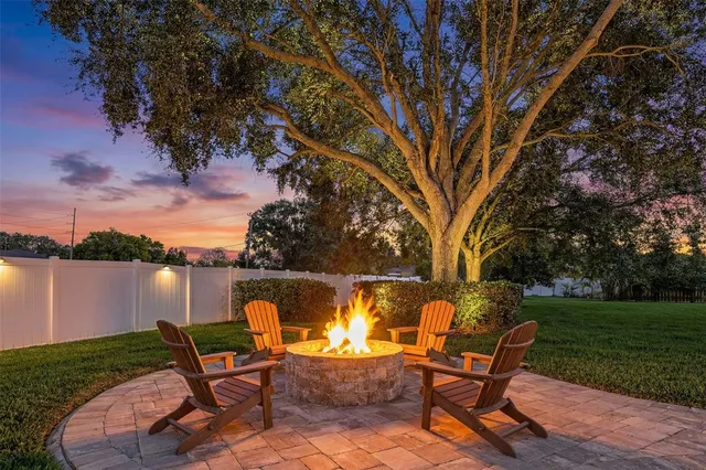 a view of a house with swimming pool and furniture