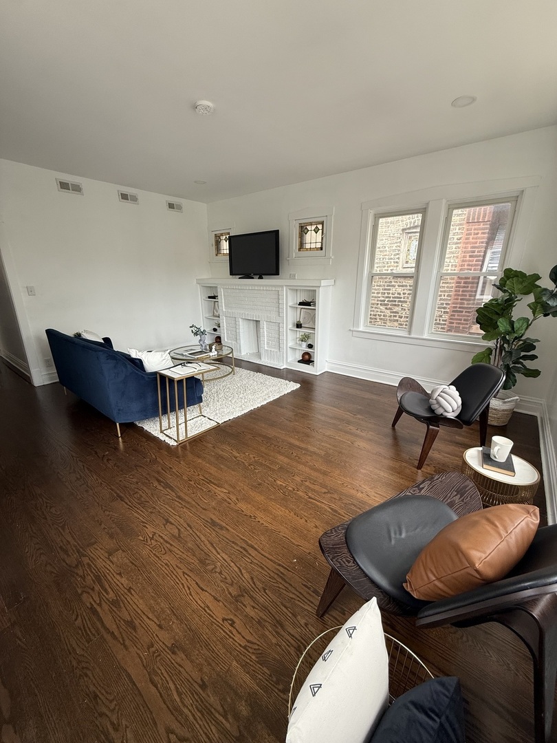 5092 West Monroe Street, Unit 1 Chicago, IL 60644 - Photo 4 of 12 a living room with furniture and wooden floor