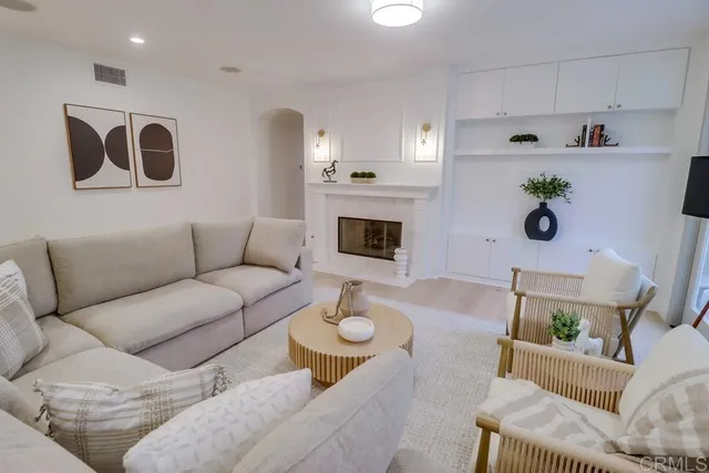 a living room with furniture and a potted plant