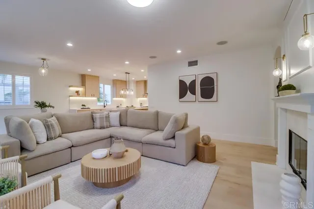 a kitchen with stainless steel appliances kitchen island granite countertop a sink and a white cabinets
