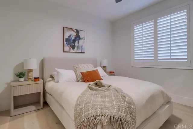 an empty room with fan and windows