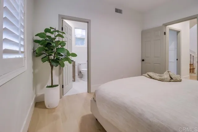 a bathroom with a granite countertop sink toilet a mirror a vanity and shower