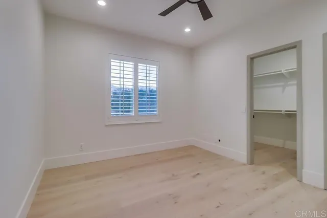 a bedroom with a bed and a potted plant
