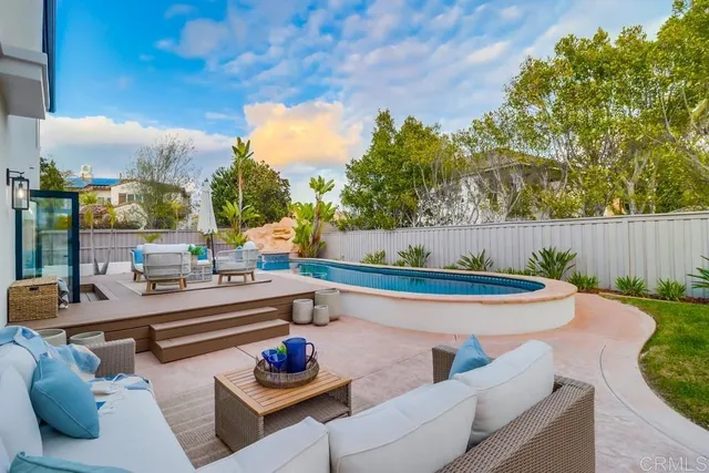 a view of house with swimming pool outdoor seating