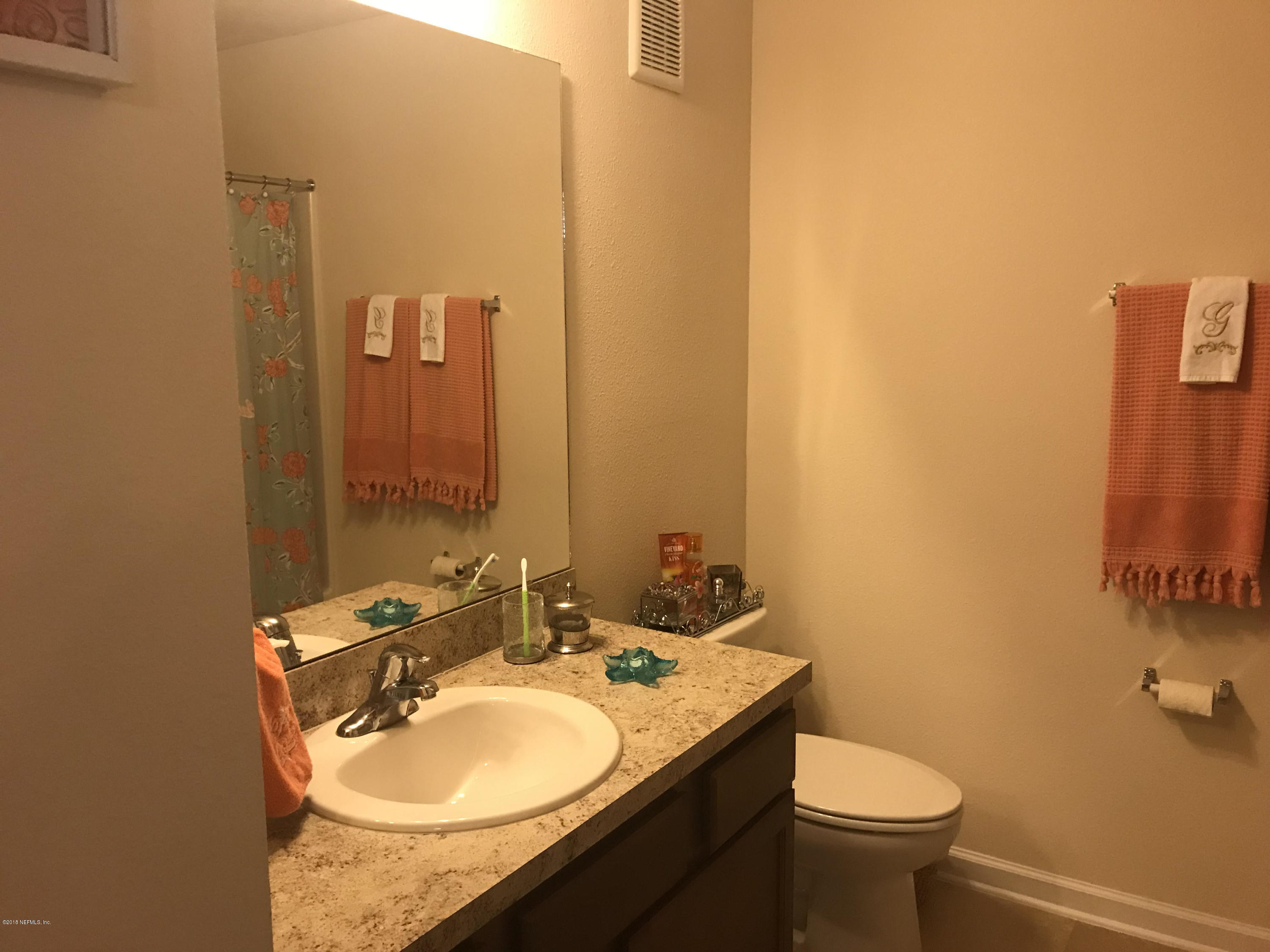 218 Larkin Place, Unit 111 St. Johns, FL 32259 - Photo 11 of 21 a bathroom with a granite countertop sink and a mirror