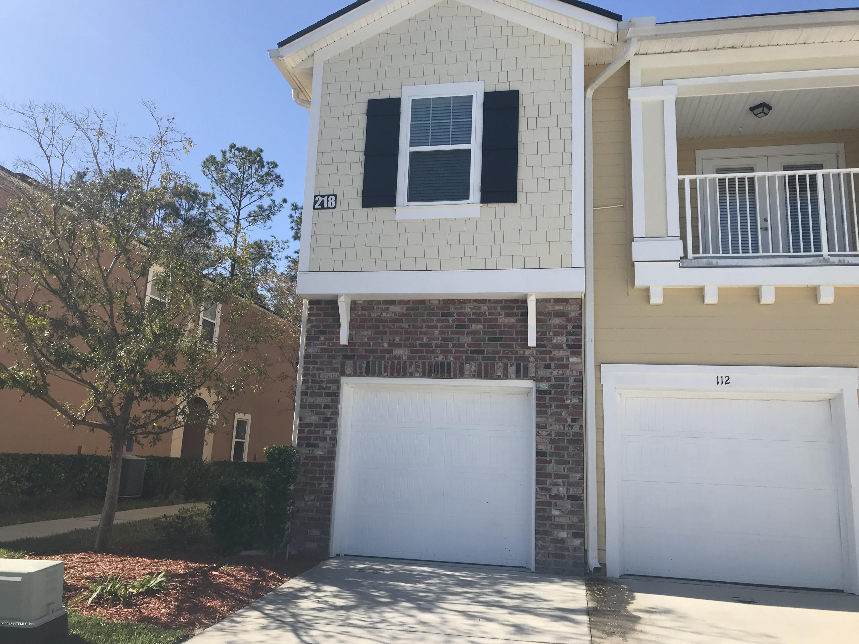 218 Larkin Place, Unit 111 St. Johns, FL 32259 - Photo 2 of 21 a front view of a house with a yard