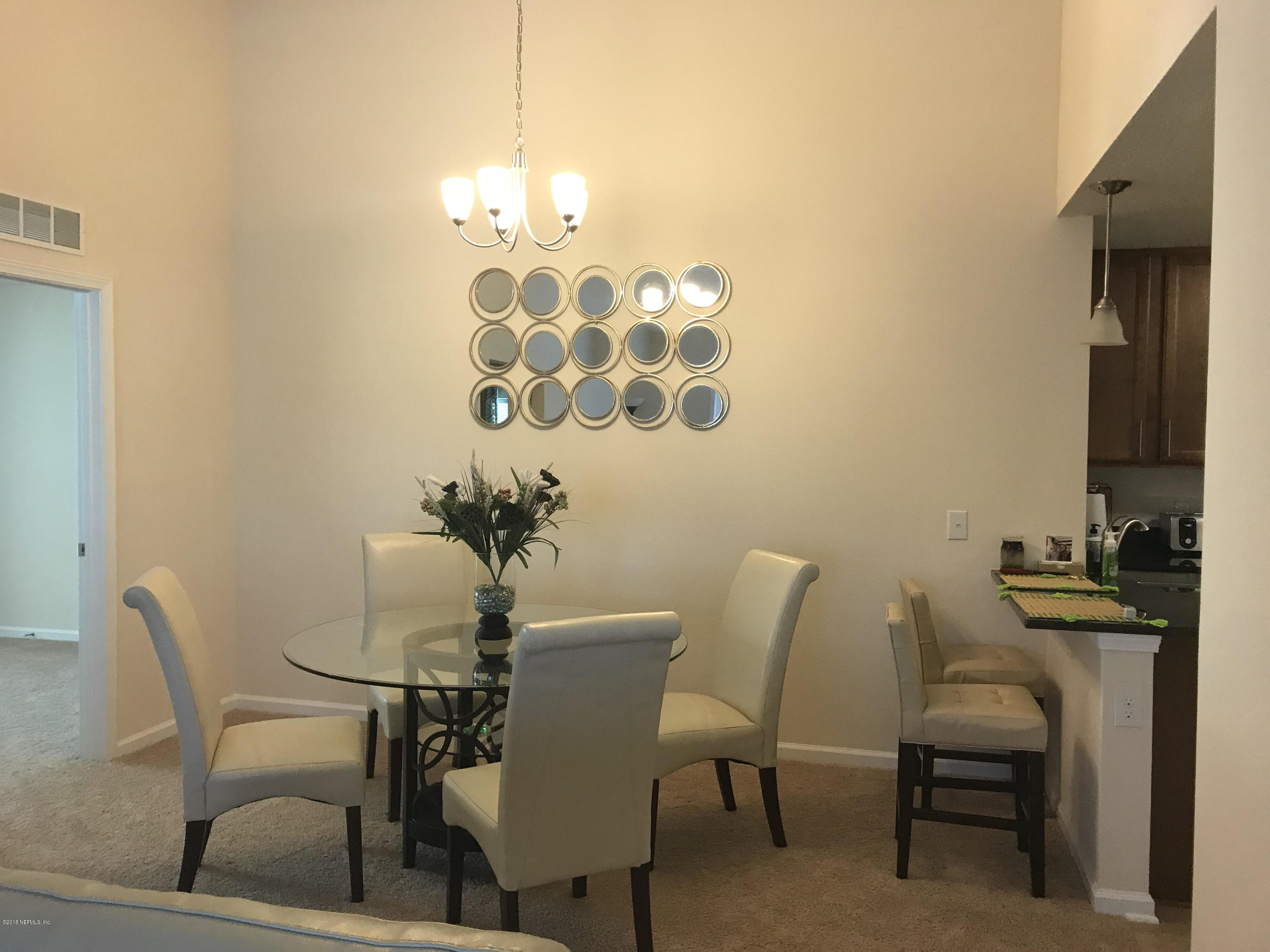 218 Larkin Place, Unit 111 St. Johns, FL 32259 - Photo 3 of 21 a view of a dining room with furniture and chandelier