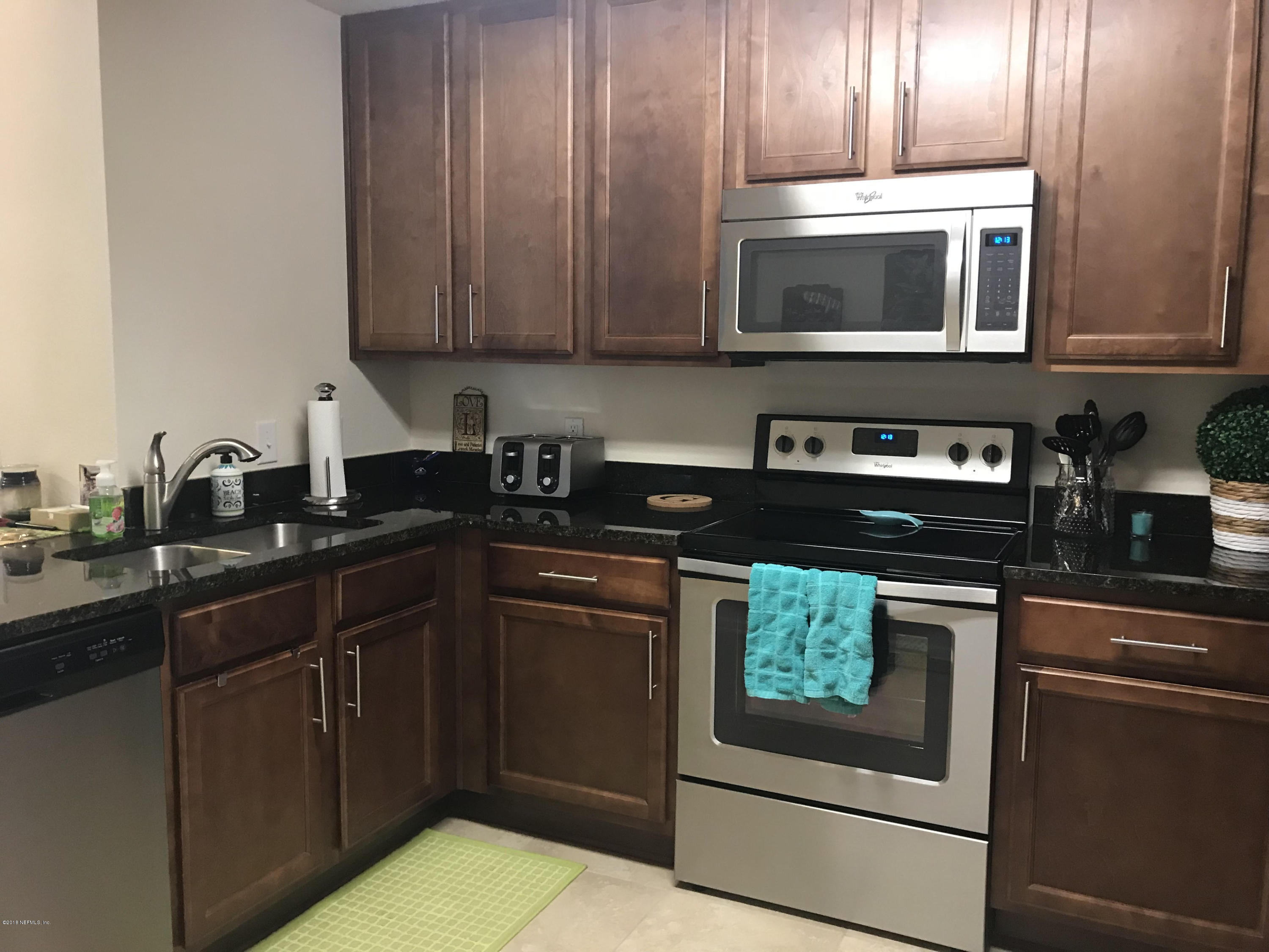 218 Larkin Place, Unit 111 St. Johns, FL 32259 - Photo 5 of 21 a kitchen with cabinets a sink and appliances