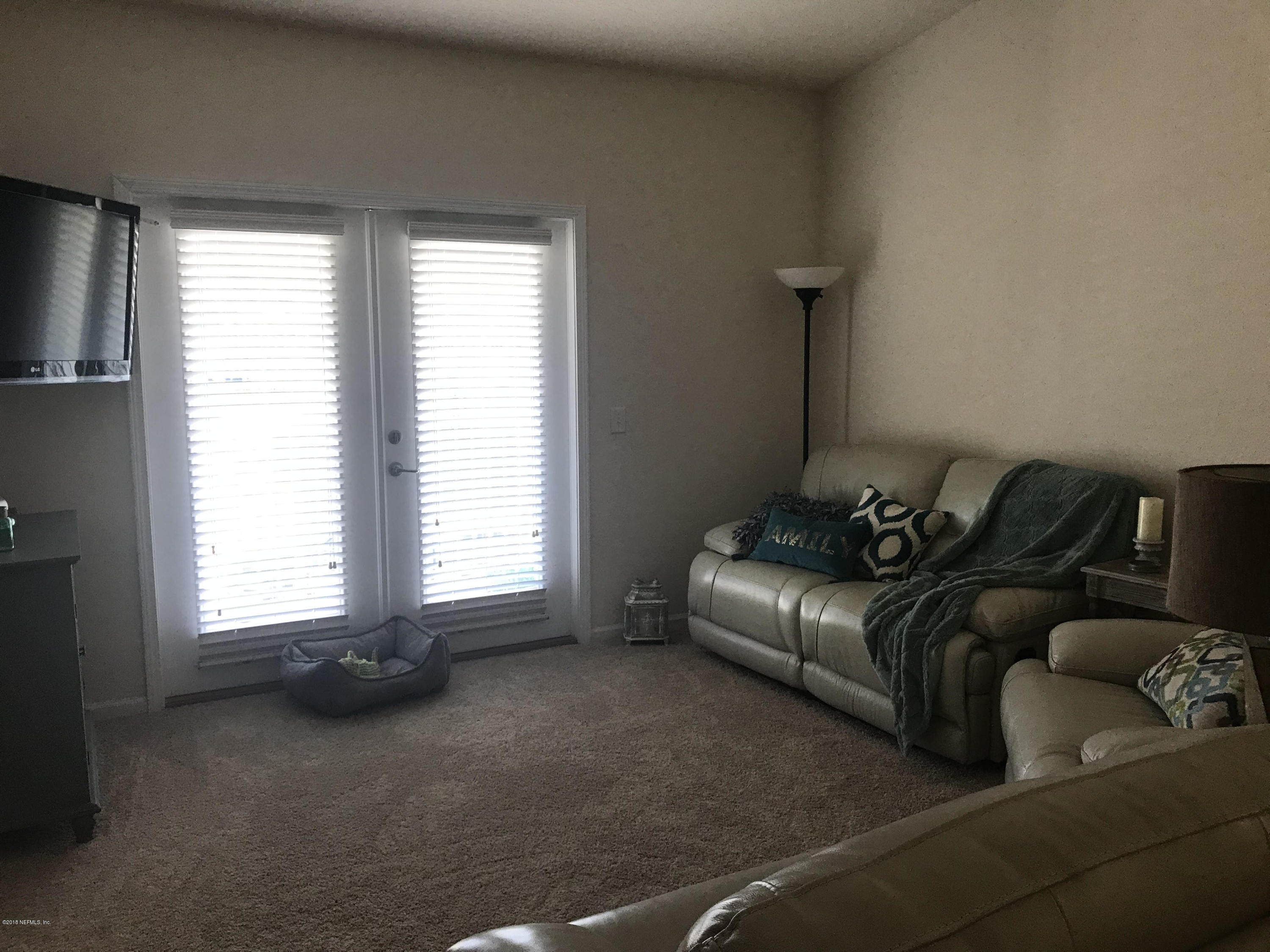 218 Larkin Place, Unit 111 St. Johns, FL 32259 - Photo 6 of 21 a living room with furniture and a window