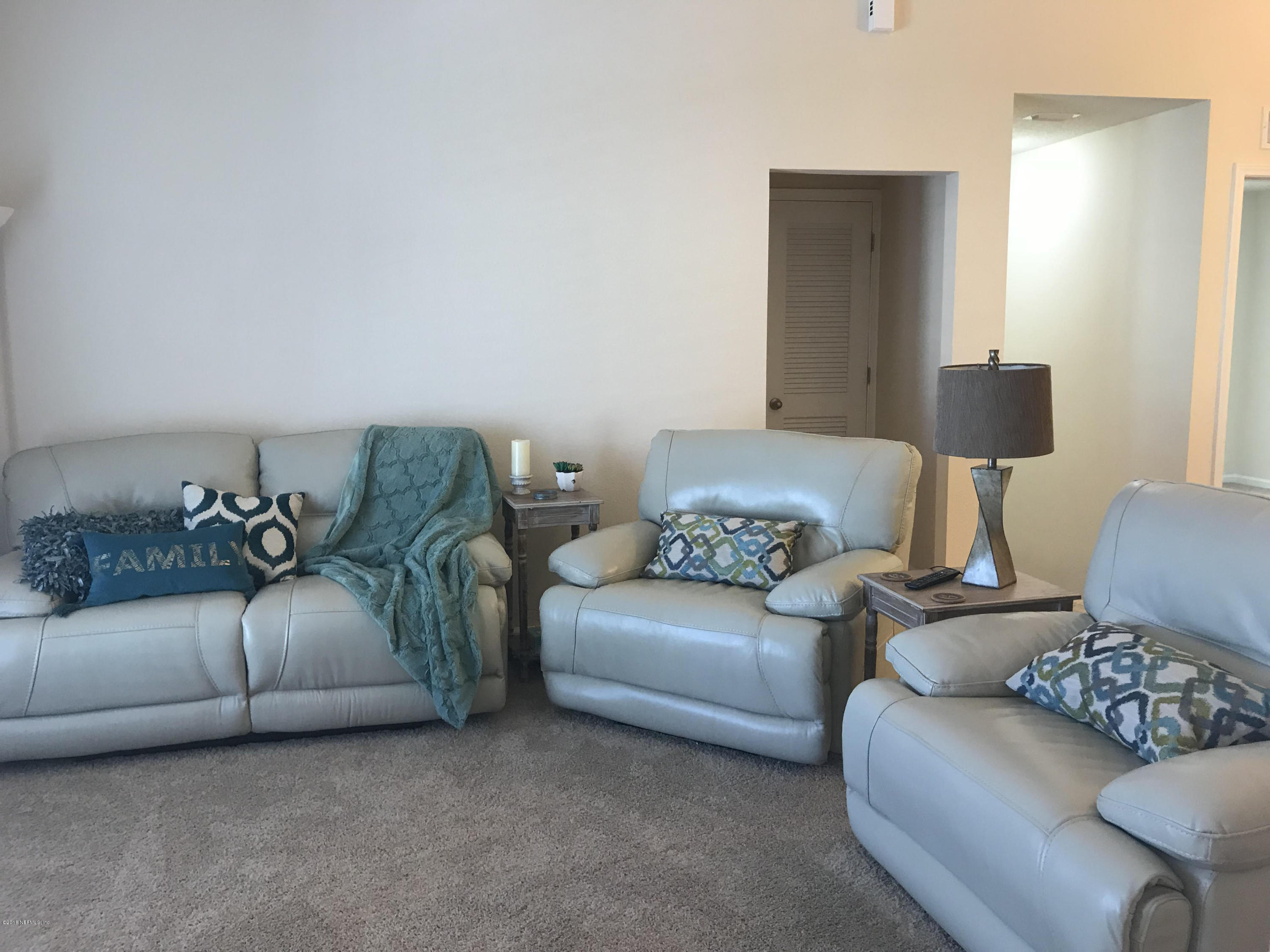 218 Larkin Place, Unit 111 St. Johns, FL 32259 - Photo 7 of 21 a living room with furniture and a couch