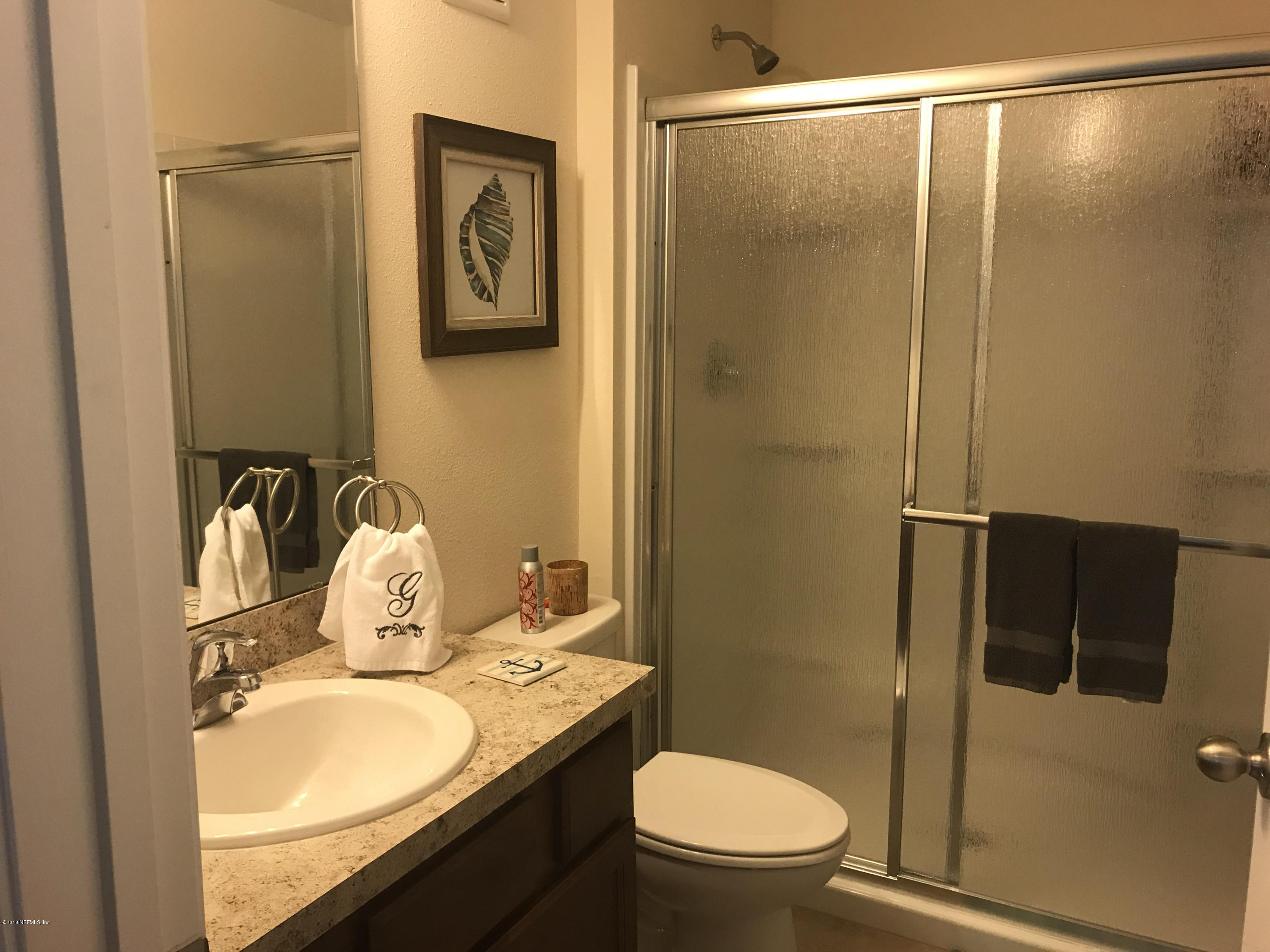218 Larkin Place, Unit 111 St. Johns, FL 32259 - Photo 9 of 21 a bathroom with a granite countertop sink toilet and shower