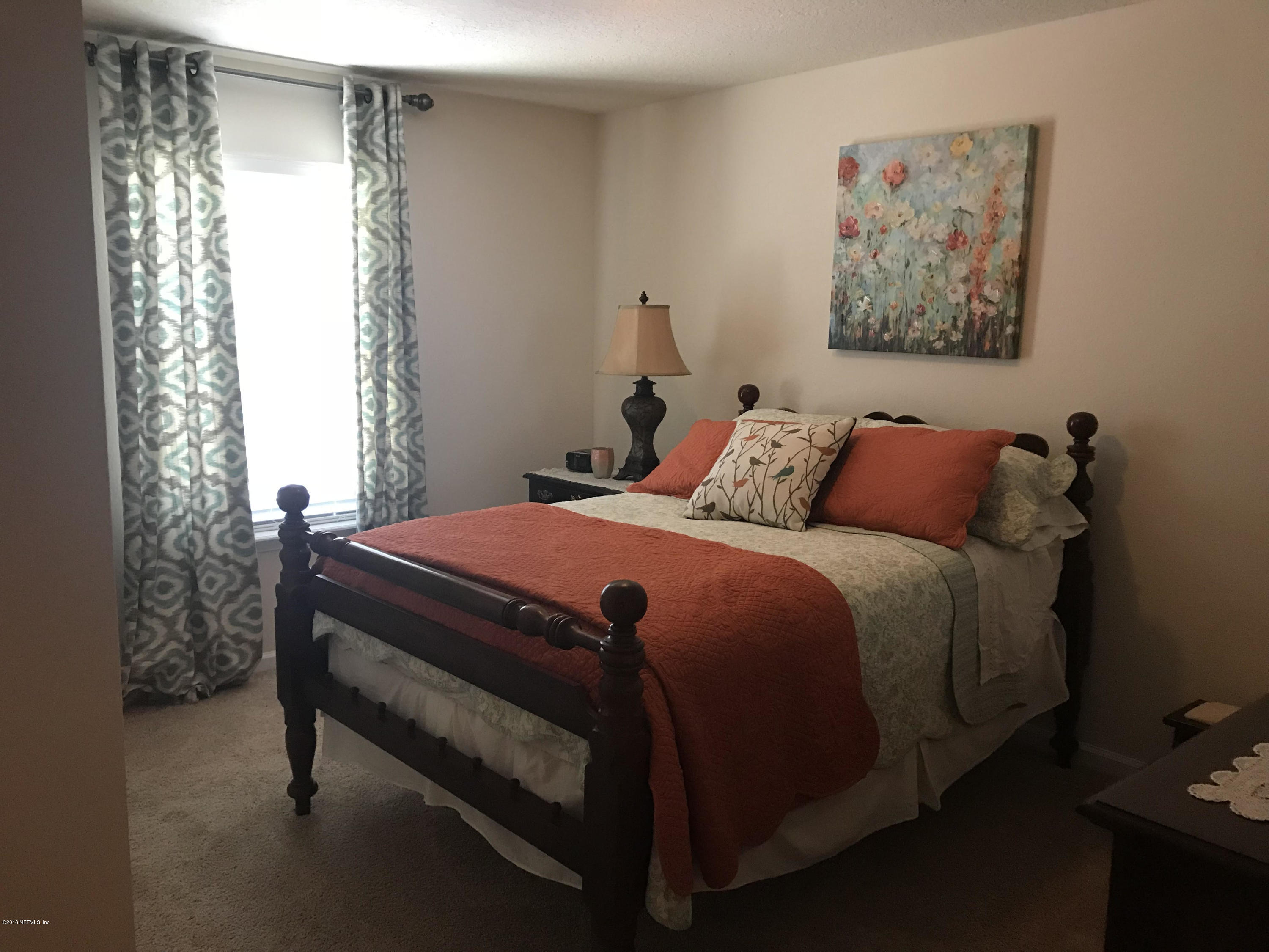 218 Larkin Place, Unit 111 St. Johns, FL 32259 - Photo 10 of 21 a bedroom with a bed and a window