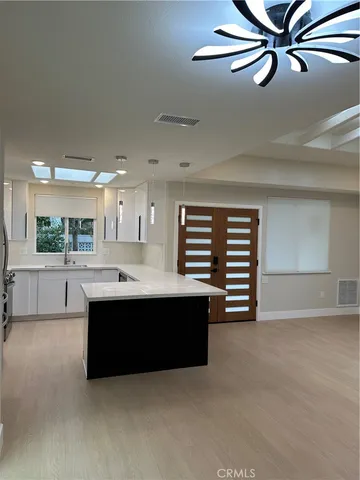 a kitchen with a stove a sink and a refrigerator