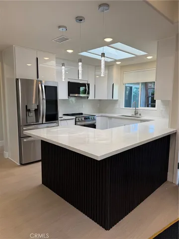 a bathroom with a granite countertop sink a toilet a mirror and shower