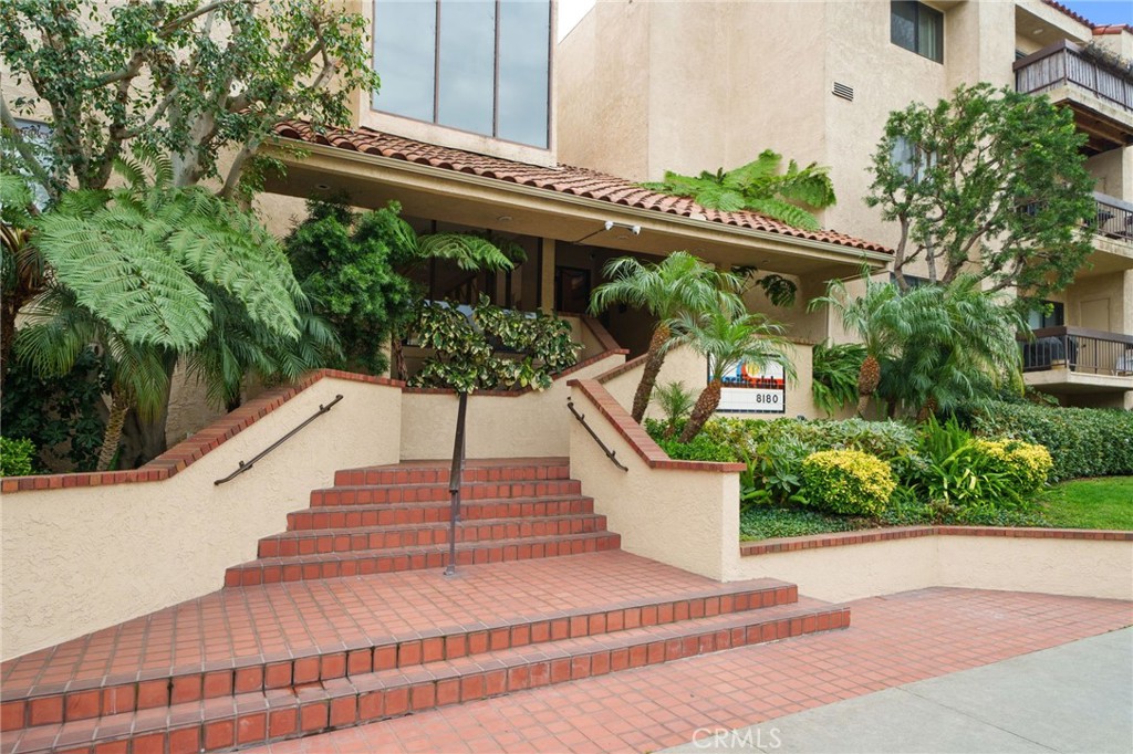 a picture of a building with a garden