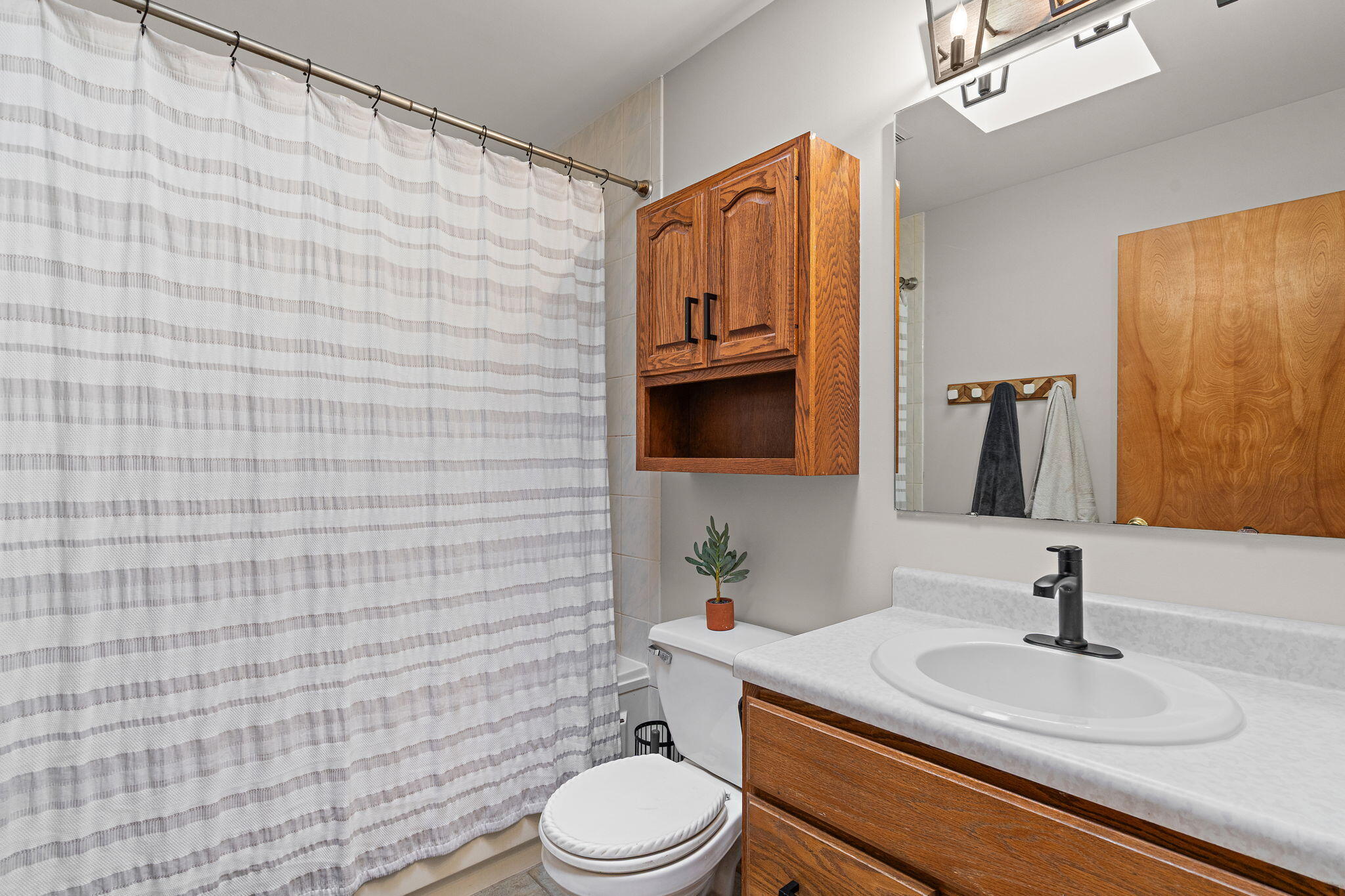 8987 Calhoun Place Crown Point, IN 46307 - Photo 14 of 28 a bathroom with a granite countertop toilet sink and mirror
