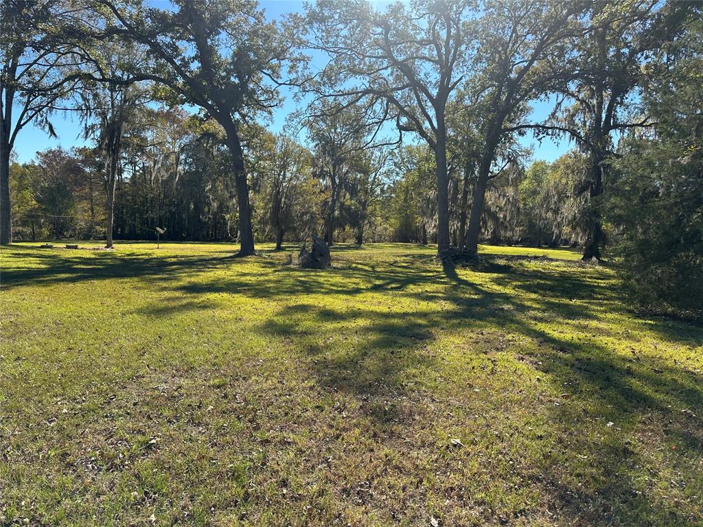 859 Clear Lake Road Mansfield, LA 71052 - Photo 2 of 2 a view of a swimming pool with an outdoor space and seating area