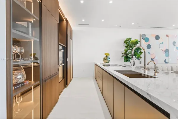 a kitchen with sink table and chairs