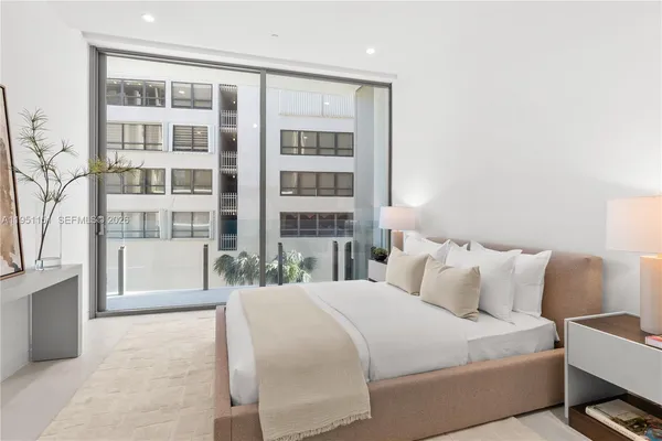 a bathroom with a double vanity sink and mirror with bathtub