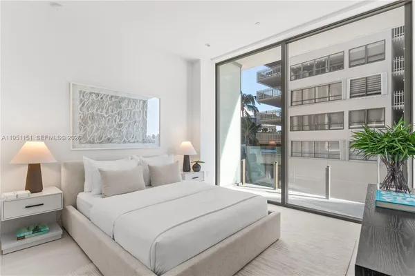 a bathroom with a double vanity sink a mirror and a bathtub