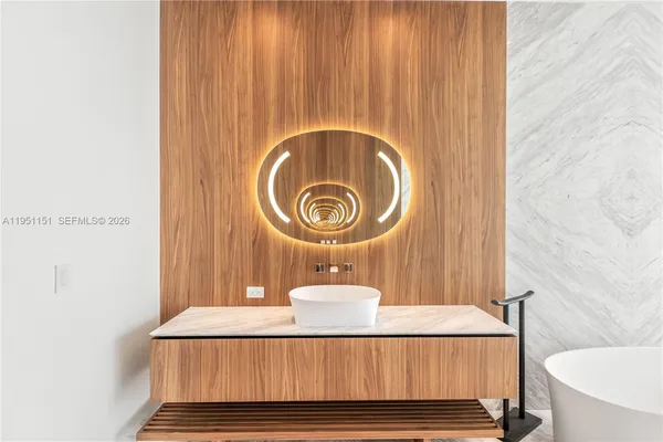 a bathroom with a tub and shower