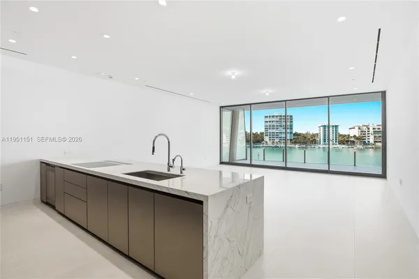 an empty room with sliding glass door and shower