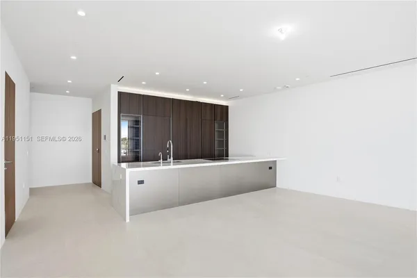 a living room with furniture a chandelier and a dining table