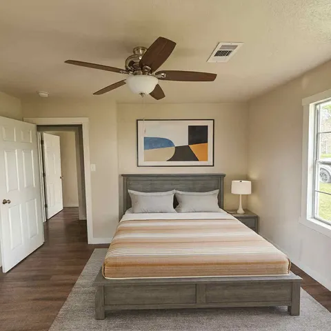 a bedroom with a bed and a window