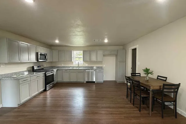 a kitchen with a table and chairs in it