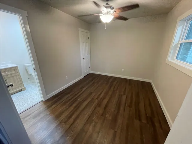wooden floor in an empty room with a mirror