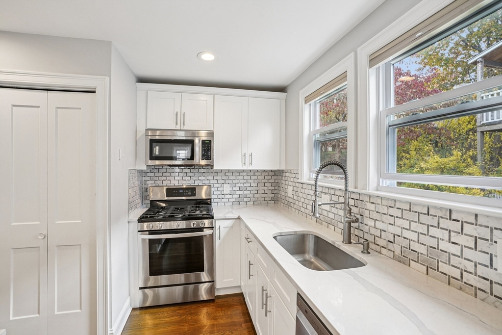 33 Slade Street, Unit 1 Belmont, MA 02478 - Photo 13 of 26 a kitchen with a sink a stove and cabinets