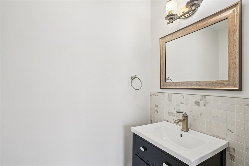 33 Slade Street, Unit 1 Belmont, MA 02478 - Photo 14 of 26 a bathroom with a sink a mirror and vanity