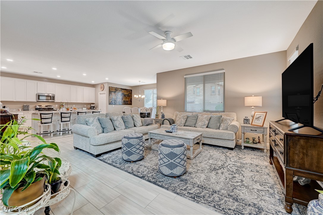 3826 Asia Road North Las Vegas, NV 89032 - Photo 1 of 30 Open concept living room, kitchen and dining room featuring ample space, large tiles and large kitchen island.
