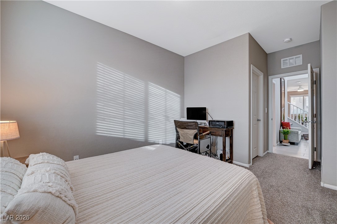 3826 Asia Road North Las Vegas, NV 89032 - Photo 13 of 30 Downstairs carpeted bedroom featuring walk-in closet and upgraded baseboards