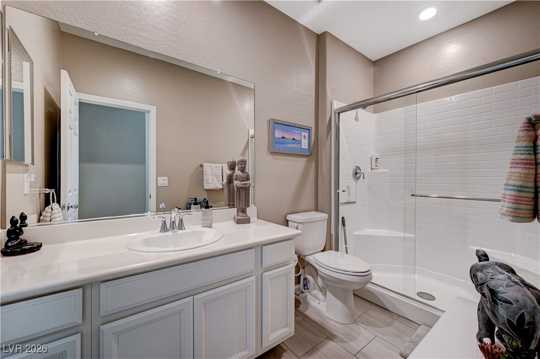 3826 Asia Road North Las Vegas, NV 89032 - Photo 15 of 30 Downstairs bathroom with vanity and a stall shower