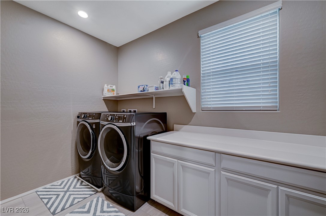3826 Asia Road North Las Vegas, NV 89032 - Photo 26 of 30 Upstairs washroom with independent washer and dryer, wood grain-like porcelain tile floors, cabinet space, and recessed lighting