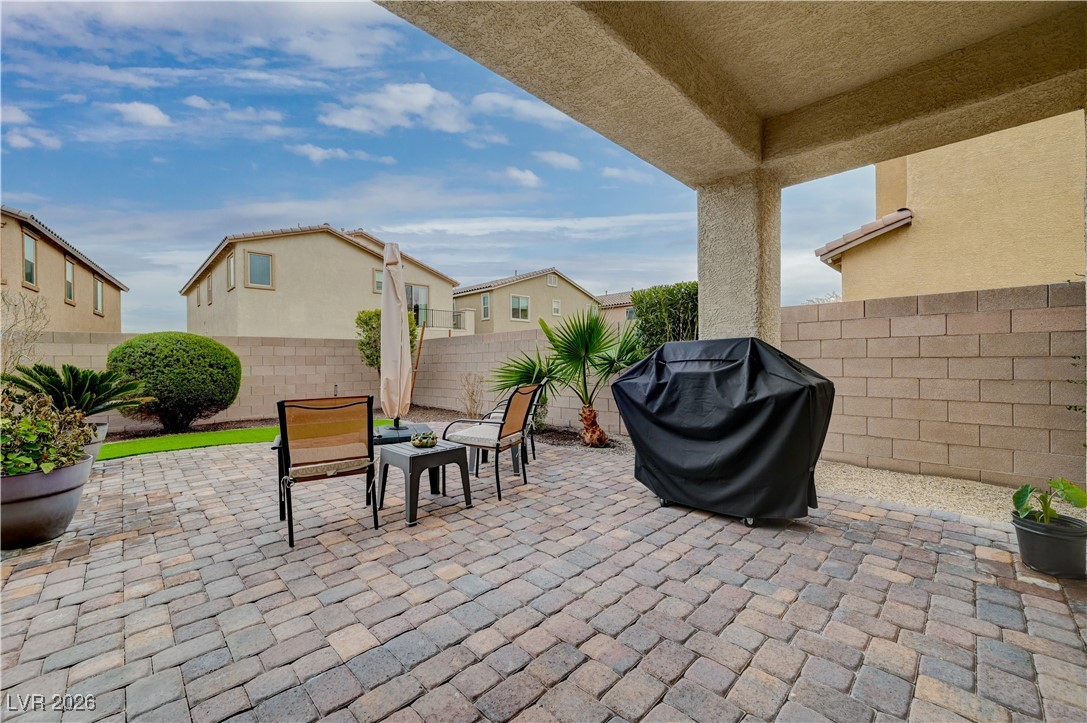 3826 Asia Road North Las Vegas, NV 89032 - Photo 28 of 30 Fenced backyard with area for grilling, a patio, and a residential view