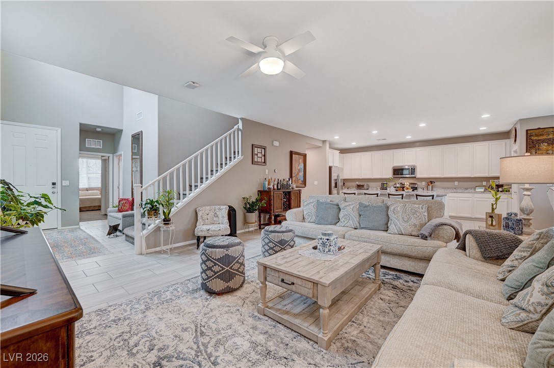 3826 Asia Road North Las Vegas, NV 89032 - Photo 6 of 30 Living area with a ceiling fan, stairs, and wood grain-like porcelain tile floors
