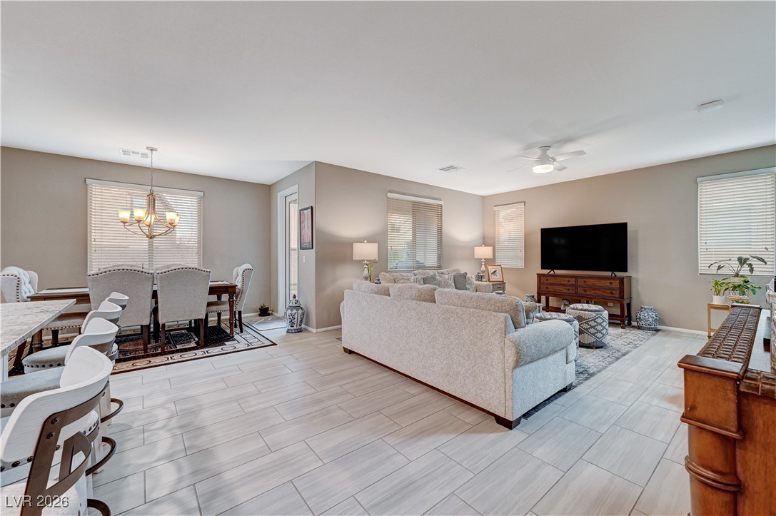 3826 Asia Road North Las Vegas, NV 89032 - Photo 8 of 30 Living area with a ceiling fan, and wood grain-like porcelain tile floors