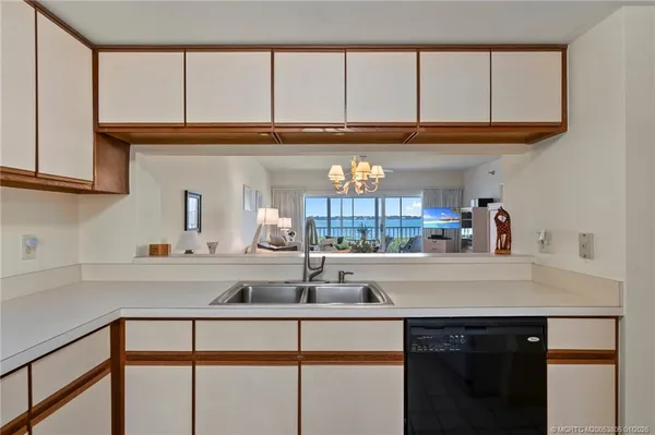 a kitchen with a sink cabinets and a window
