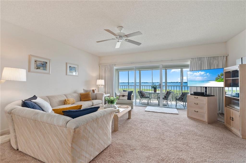 164 Northeast Edgewater Drive, Unit 2105 Jensen Beach, FL 34957 - Photo 12 of 35 a living room with furniture and a window