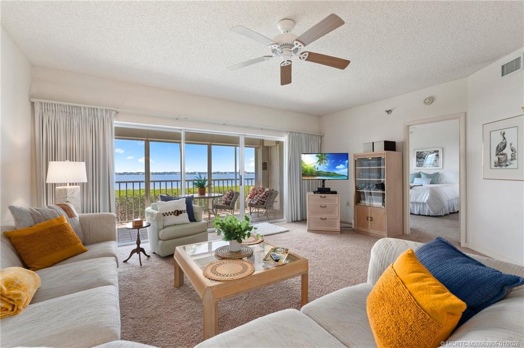 164 Northeast Edgewater Drive, Unit 2105 Jensen Beach, FL 34957 - Photo 13 of 35 a living room with furniture and a large window