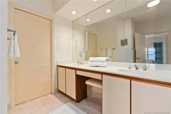 a bathroom with a double vanity sink and a mirror